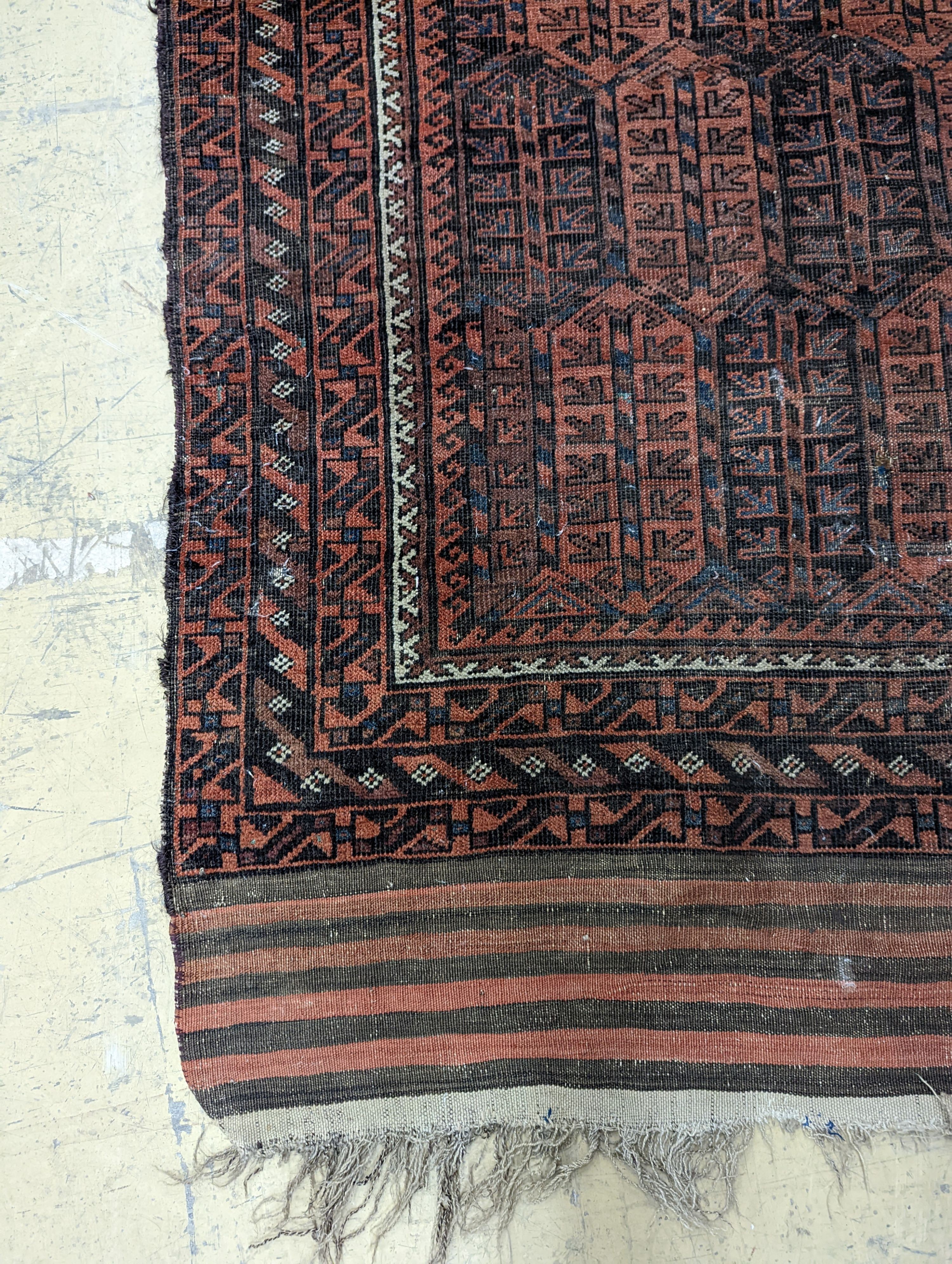 A Belouch red ground rug and a prayer rug, largest 178 x 106cm